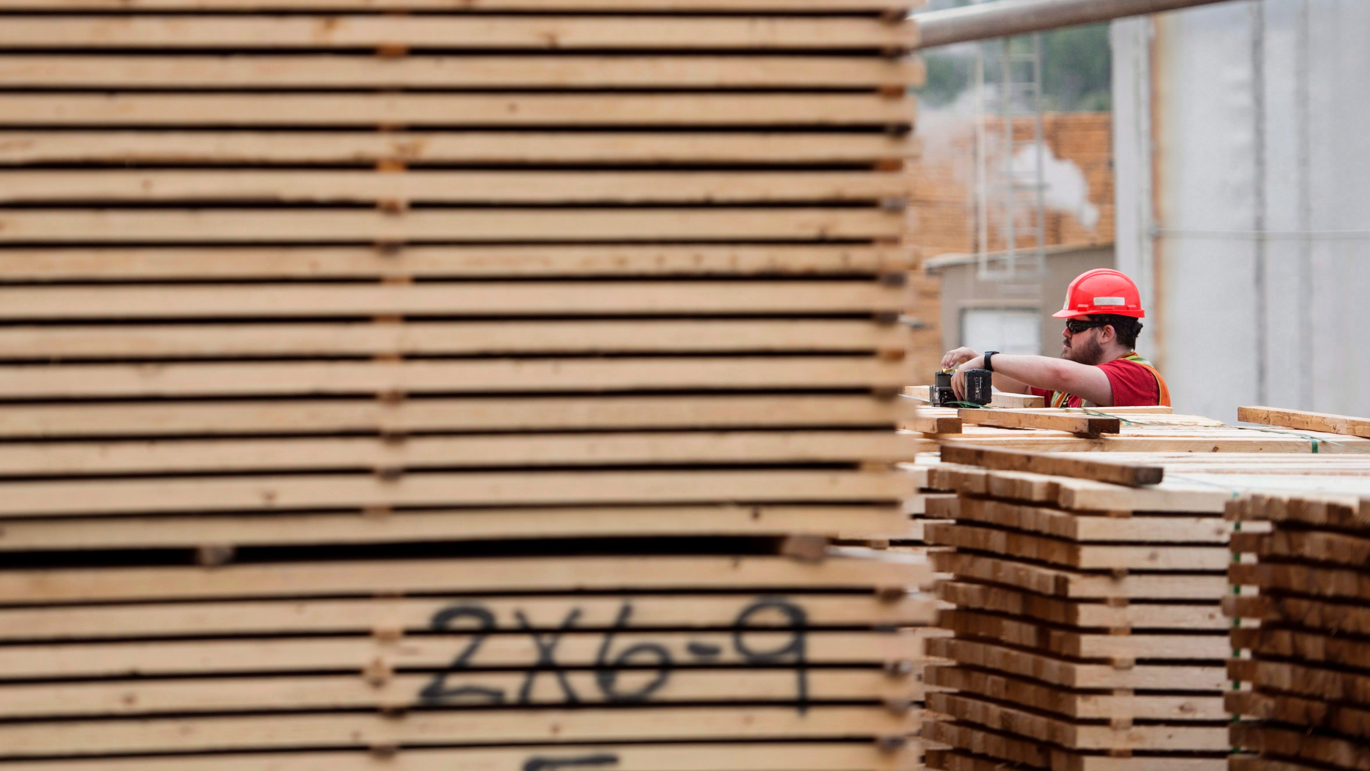 An employee works in the lumber yard at Ledwidge Lumber Co. in Halifax on Wednesday, May 10, 2017. THE CANADIAN PRESS/Darren Calabrese