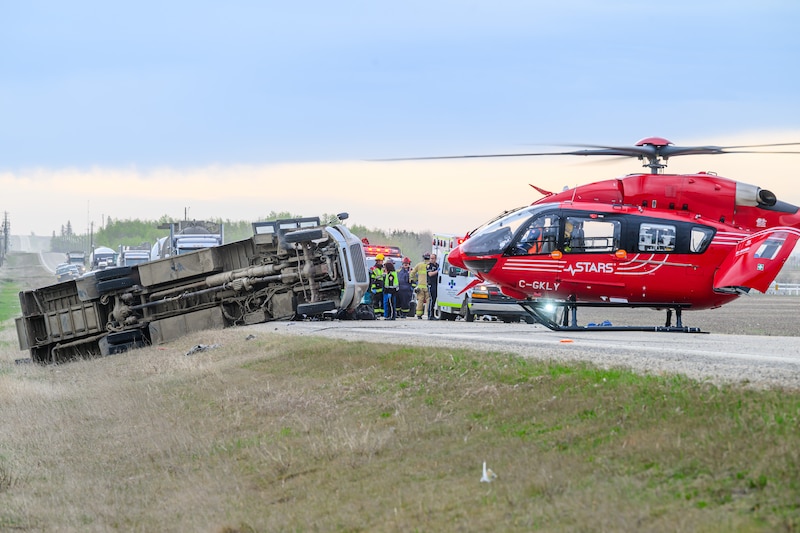 A STARS medical helicopter is shown on Highway 672 near Beaverlodge, Alta., west of Grande Prairie, Alta., after a bus rollover resulted in several passengers being taken to hospital on Wednesday, May 13, 2026. THE CANADIAN PRESS/William Vavrek
