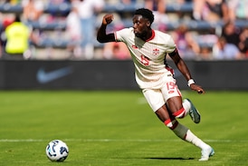 Injured Canada captain Alphonso Davies rejoins team but it's not clear when he'll play