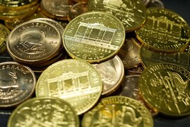 Gold declines on stronger U.S. dollar in thin trading 